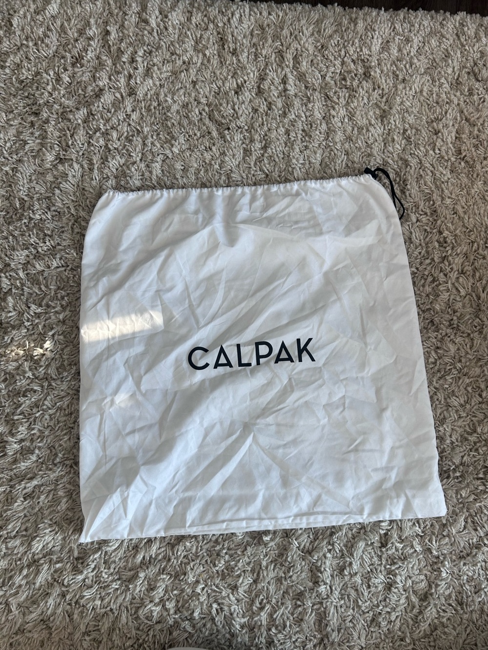 Calpak White Drawstring Accessory Pouch with Black Logo
